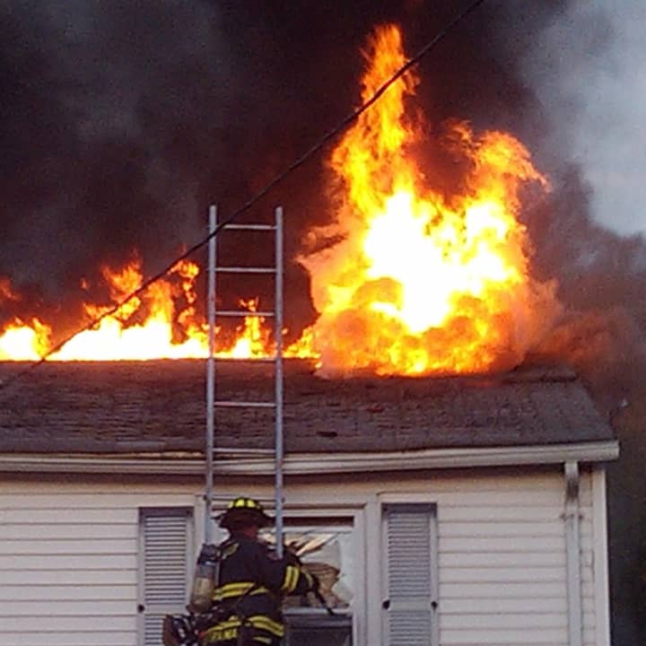 The wind-blown three-alarm fire began in the basement or first floor of the 2½-story house on Halstead Place house before flames eventually shot through the roof. 