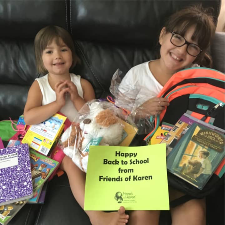 Emma and Mia show off their back to school supplies from Friends of Karen.
