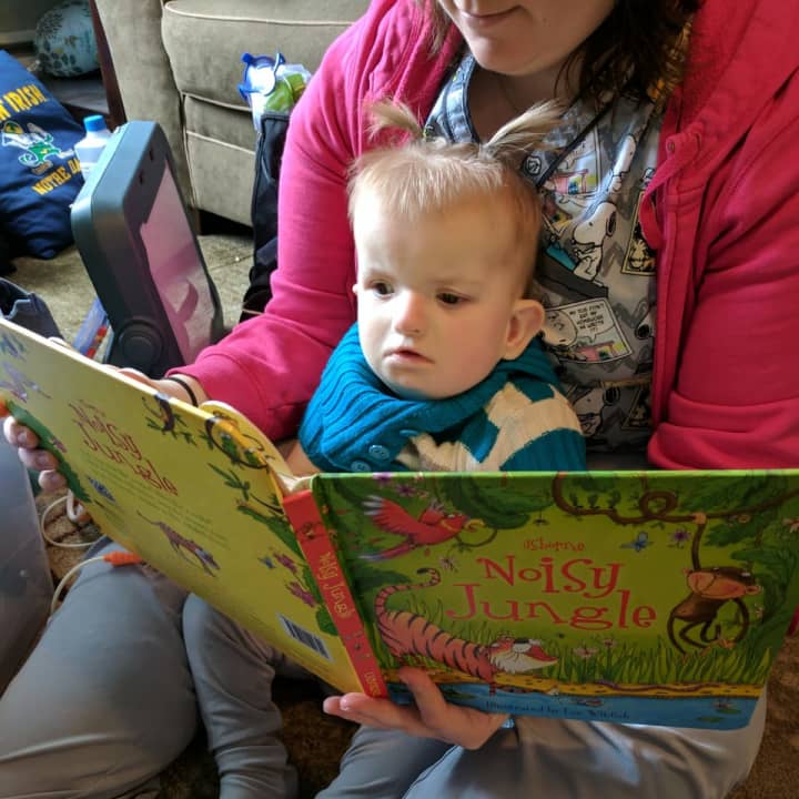 Emmeline of Norwood, 21 months, reads with her nurse at CHOP.