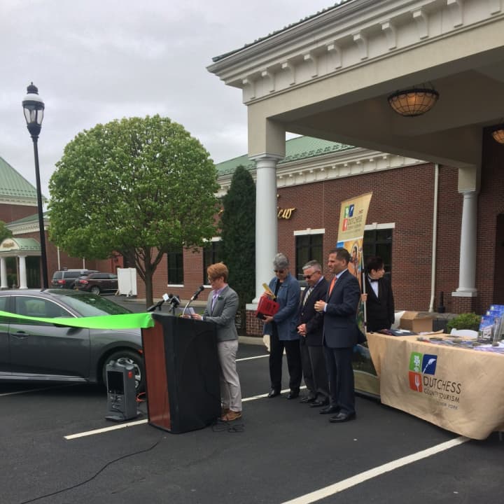 Erica Bacon discusses the many benefits of Zipcar at a recent launch ceremony in Beacon, while (L to R) Mary Kay Vrba, Dutchess Tourism, Inc. President &amp; CEO, Mayor Randy Casale and Dutchess County Executive Marcus Molinaro look on.