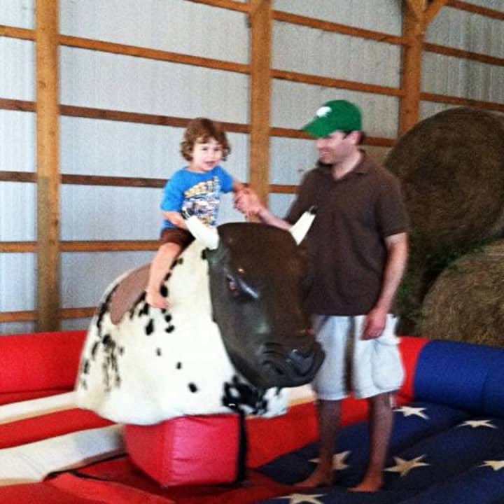 This little one gave the mechanical bull a try at the 2012 Farm Festival.