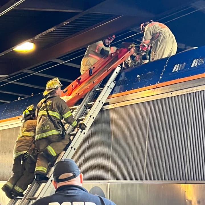 DC Fire and EMS working to remove the victim from atop a rail car during an earlier incident at Union Station. This was taken after the high-voltage catenary was de-energized, grounded, and tested in order to make the scene safe