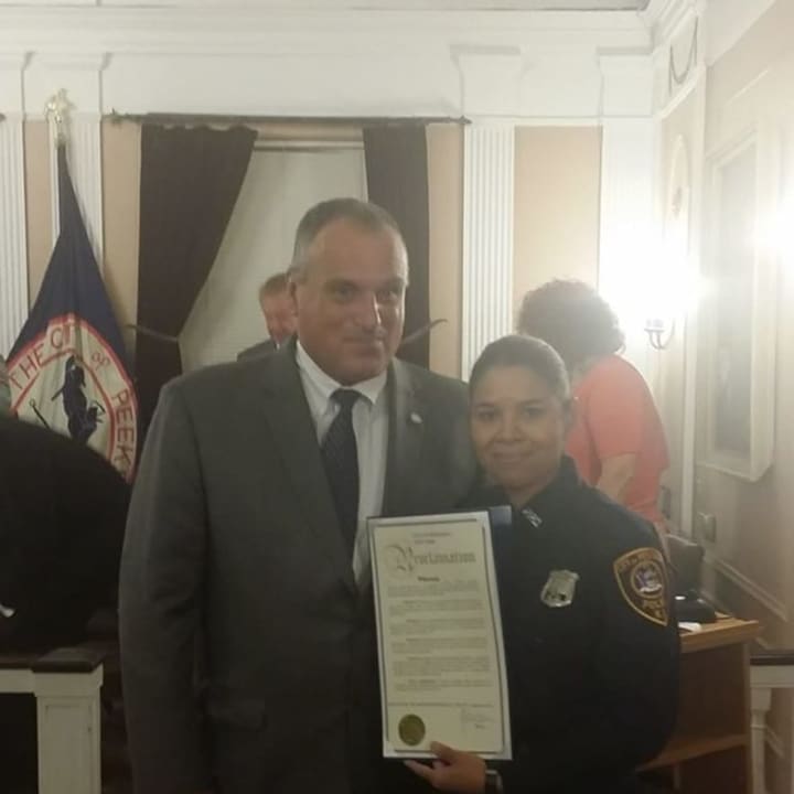 Peekskill police Officer Elizabeth Folch was honored for her work with the Hispanic community Monday. Presenting the proclamation was Mayor Frank Catalina.