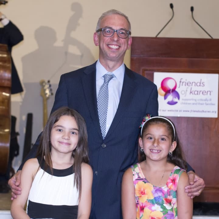 Former patients Mia and Sophia stand with honoree Dr. Adam Levy.