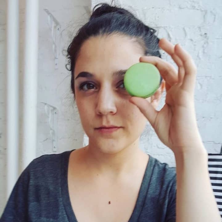 A Woops! patron snaps a photo with her colorful macaron before it disappears.