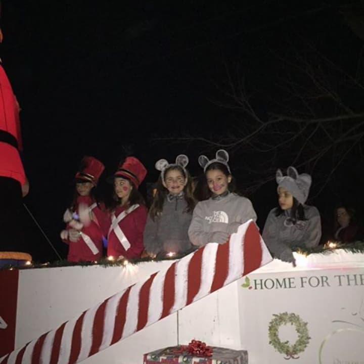 Gia Macaluso of Westwood and friends smile from a float in the Westwood Parade of Toys.