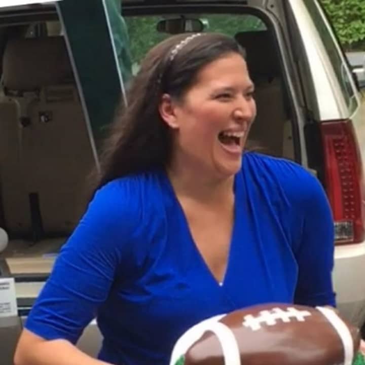Ossining resident Gina Gray hold a football cake she made while competing to get picked for the Food Network&#x27;s &quot;Chopped.&quot;
