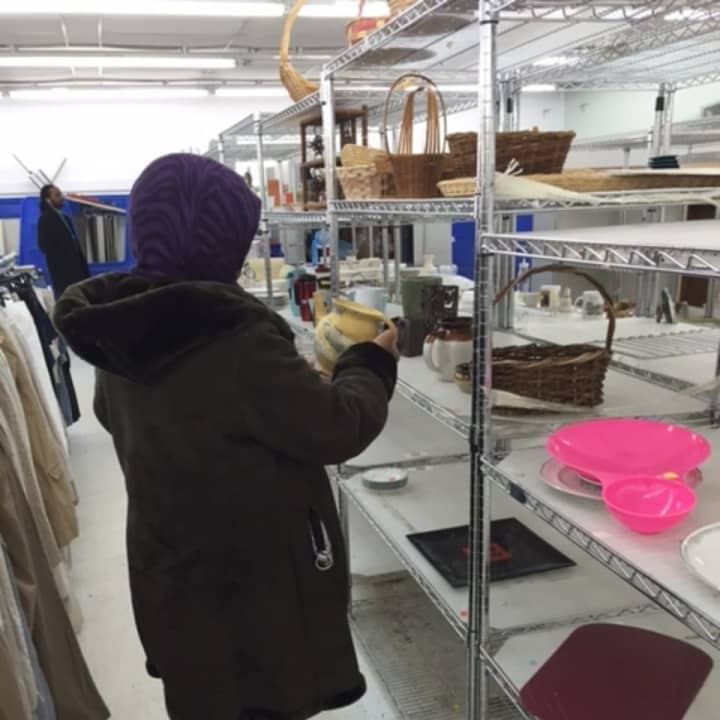 A customer examines a vase, one of the few remaining items at the Goodwill store in Croton-on-Hudson Tuesday. The longtime thrift shop is closing by the end of this month.