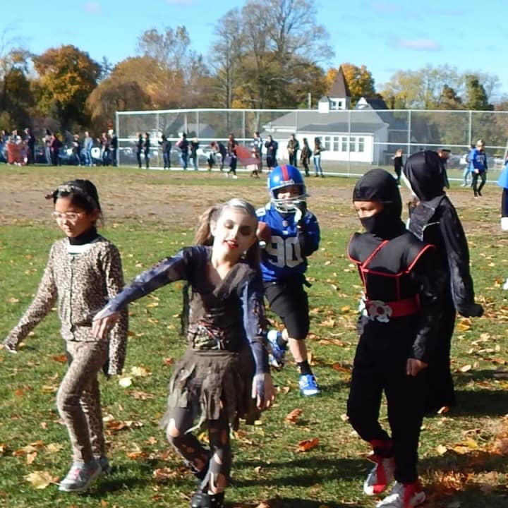 Cottage Lane Elementary staff and students enjoyed a walk on the “other” side in their Halloween costumes.
