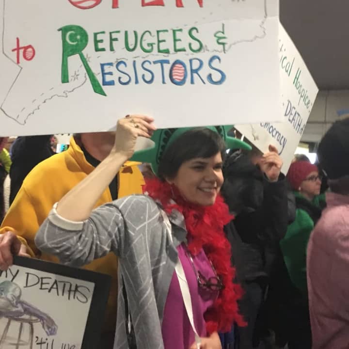 Ann Hughes, who was raised in Fairfield and now lives in Easton, calls for an open &#x27;Overground Railroad&#x27; to offer sanctuary for refugees as she joins the protest at Bradley Airport.