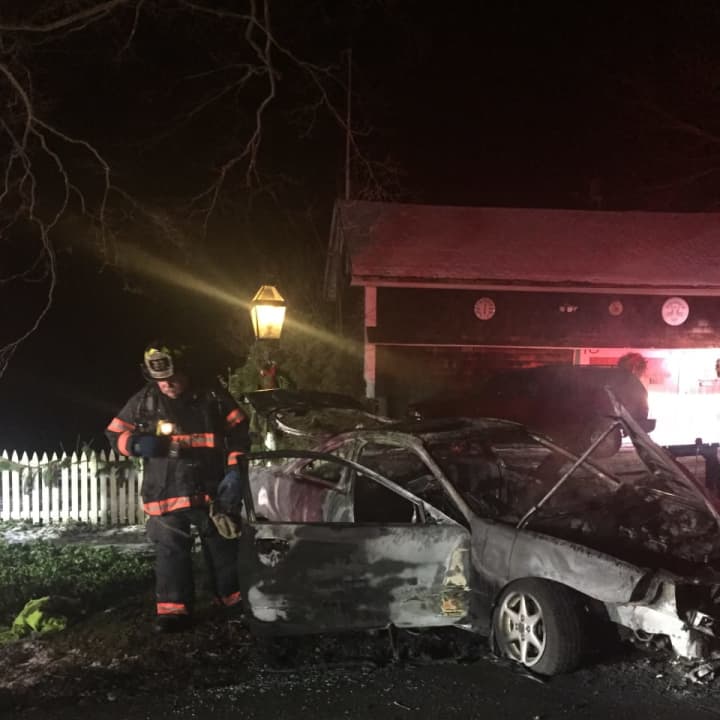 Two people were injured when a car rolled over and exploded on Long Ridge Road in Danbury on Saturday morning