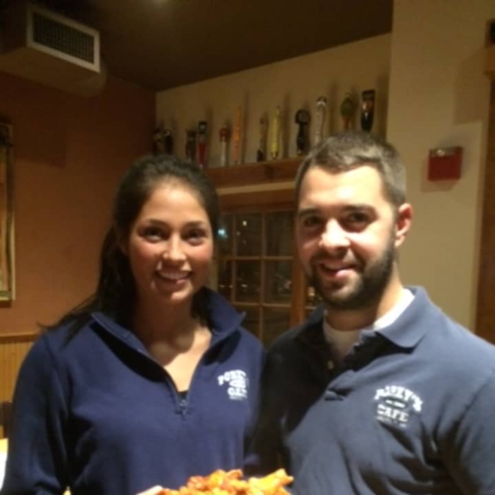 Monica Piccirillo and Terry Stroz with a plate of Porky&#x27;s wings.