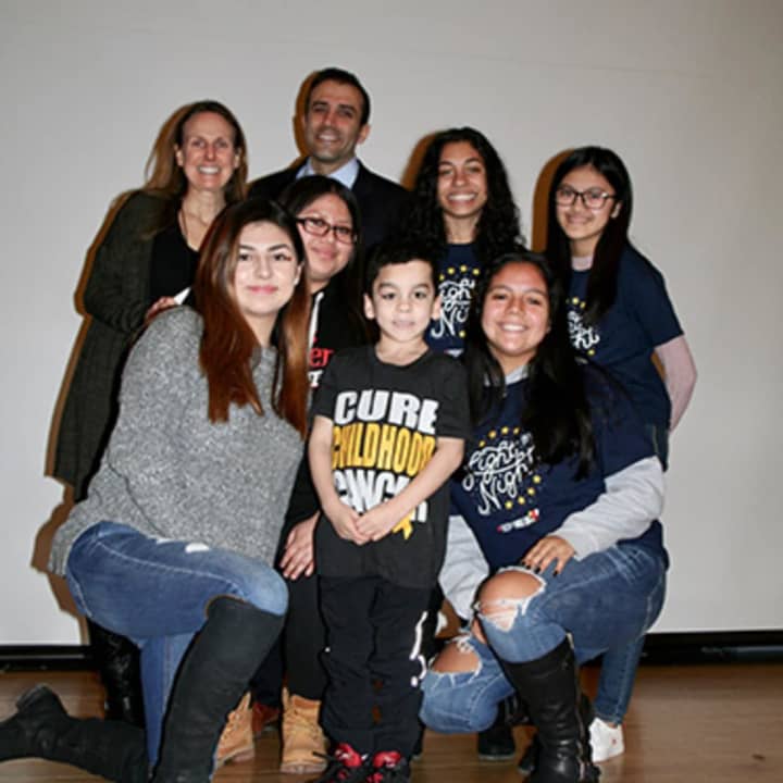 Gio, a 6-year-old Ossining boy helped by Elmsford students who are running a fundraiser related to blood cancer research, with teacher Lisa Watson and Alexander Hamilton High School Principal Joseph Engelhardt.