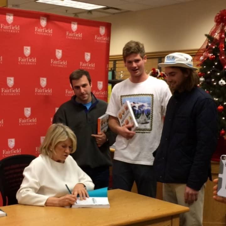 Martha Stewart signs books for Fairfield University students Tom Branca, Michael Wallace and Willie DeWitt.
