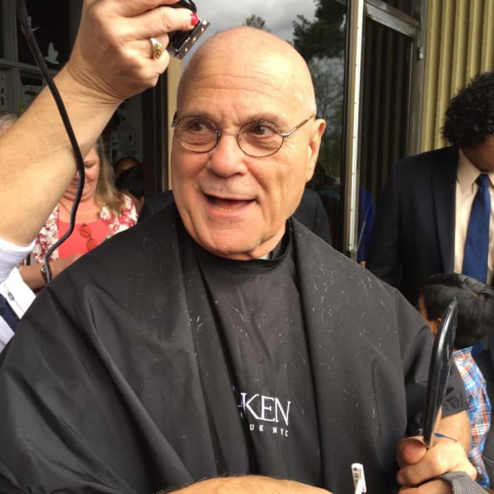Father Michael Boccaccio, pastor of St. Philip Church in Norwalk, shaved his head and mustache. He did this after the 30 Hour Famine teen group at the church succeeded in his challenge to them to raise $60K to end world hunger.