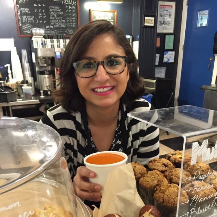 Reading Room&#x27;s Assistant Manager Suseth Garcia holding the creamy tomato soup.