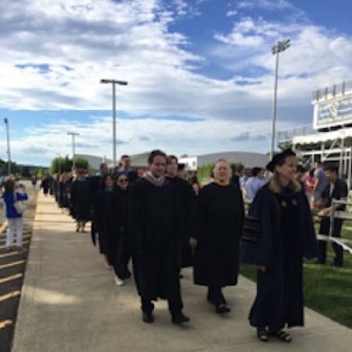 Superintendent Colleen Palmer leads the processional at the Weston High graduation on Monday.