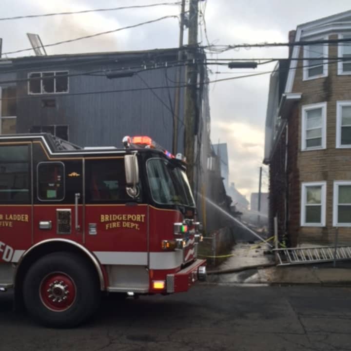 The rear of an apartment building collapsed at 215 Charles St. in Bridgeport during a New Year&#x27;s Eve fire.