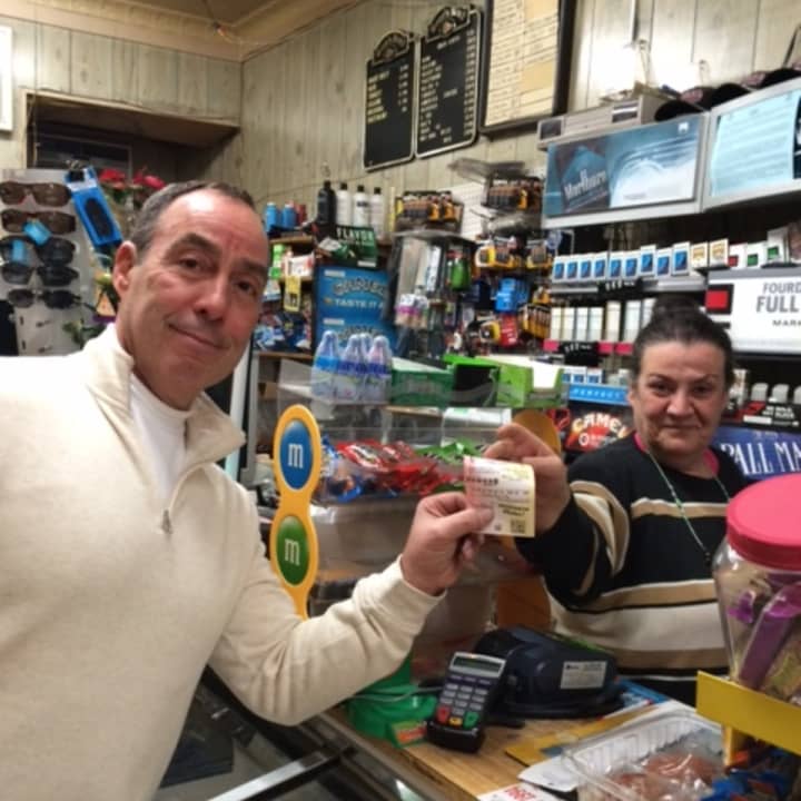 Bill John of Trumbull buys his Powerball ticket Thursday from Nada Ghalayini at Nick&#x27;s Grocery in Bridgeport.