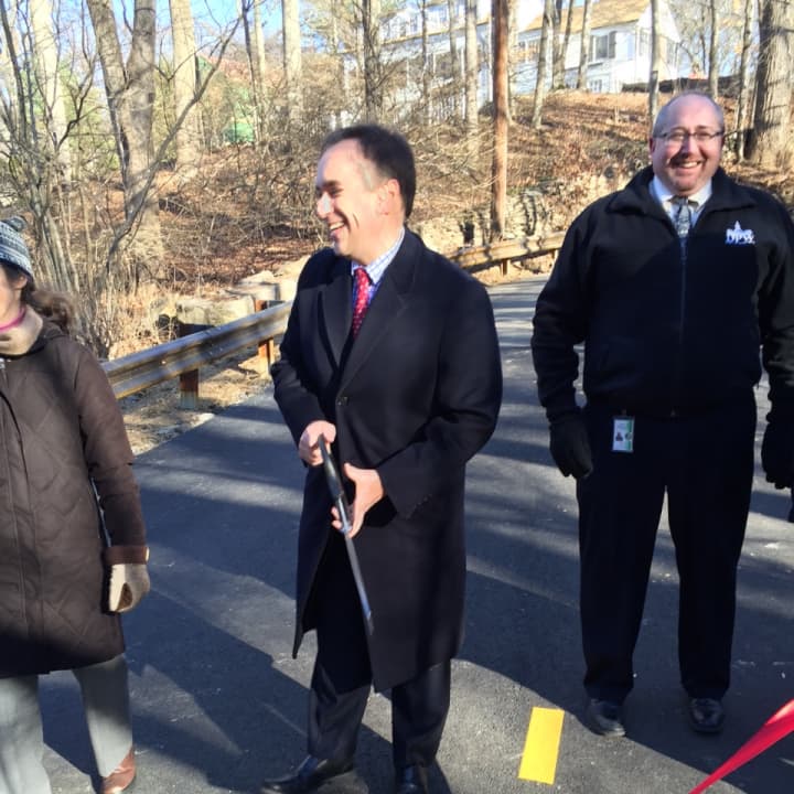 First Selectman Peter Tesei cuts the ribbon on the West Old Mill Road Bridge Monday.