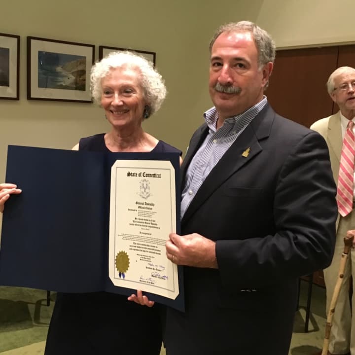 Retiring Westport Director of Human Services Barbara Butler receives a citation from state Rep. Jonthan Steinberg (D-Westport). He said Butler was &#x27;sensitive to the hardships created for our most vulnerable citizens and responded to every one.&#x27;