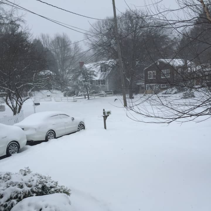 Snow blanketed neighborhoods in Greenwich, covering streets, lawns and cars Saturday afternoon.