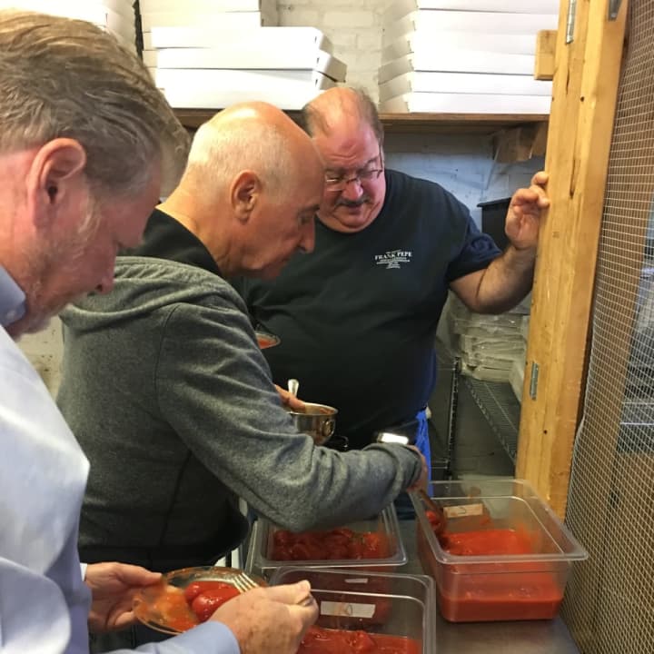 Ken Berry, left, ,Frank Pepe&#x27;s chief executive officer, and co-owners Frank Rosselli and Gary Bimonte test the tomatoes for all of Frank Pepe&#x27;s 2017 pizzas.