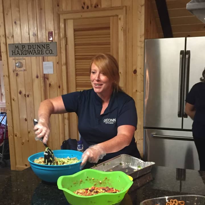 UConn Extension Registered Dietician Heather Peracchio serves up some healthy food at the last session of a summer program at Fodor Farm Monday night.