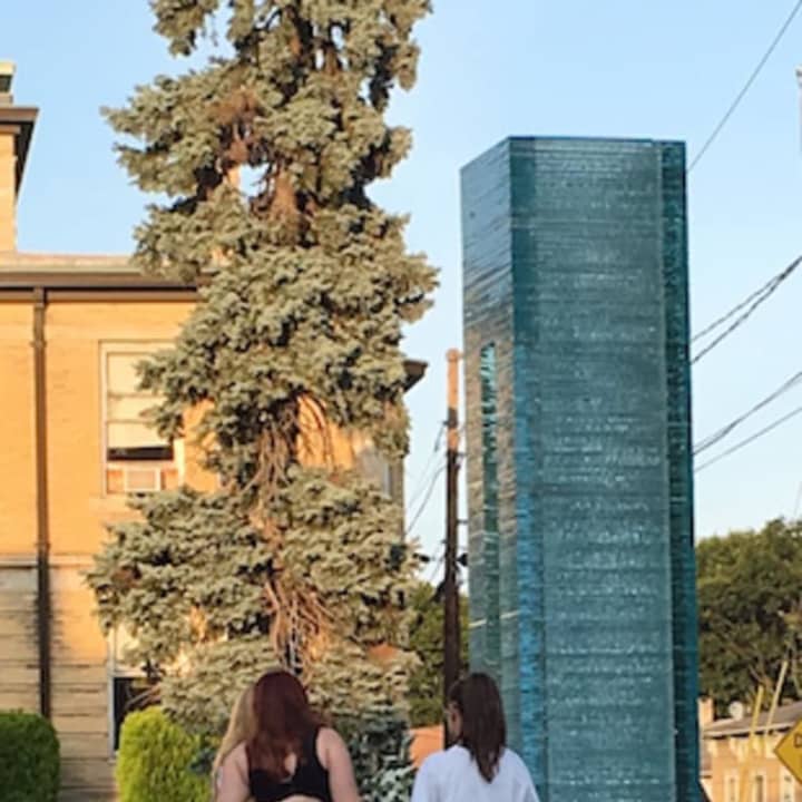 Amanda and Robyn Higley, and their mother Vycki Higley Pratt, pause at Danbury&#x27;s Sept. 11 memorial sculpture at the end of Monday evening&#x27;s Remembrance Ceremony.