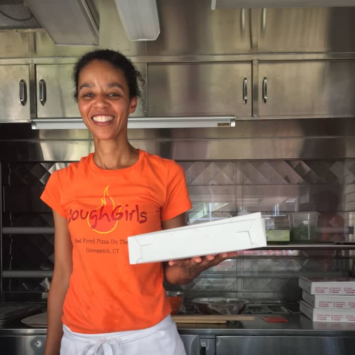 Louise Joseph works in her pizza truck — Dough Girls — parked outside of Greenwich Library on Friday.