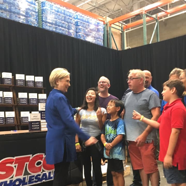 Hillary Clinton greets the first two families in line at her book signing Saturday at Costco in Brookfield.