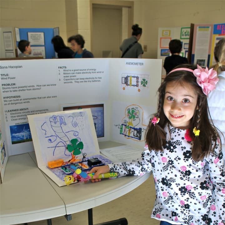 A student showing off her project at the science fair.