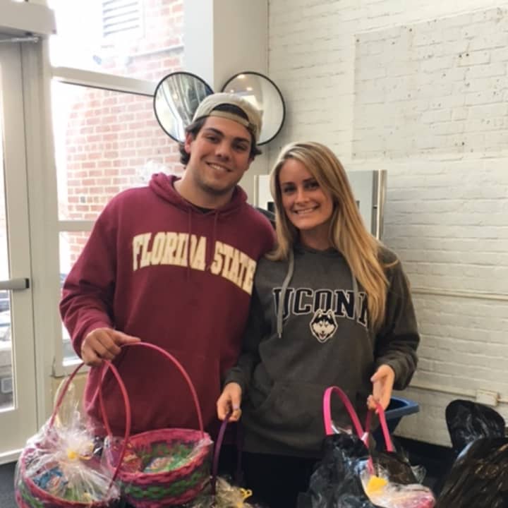Delivering the gift baskets with a smile are Anthony DiMatteo of Bethany, left, and Alida Ballou of Southbury, right. Missing from the photo is Jessica DiMatteo of Bethany.