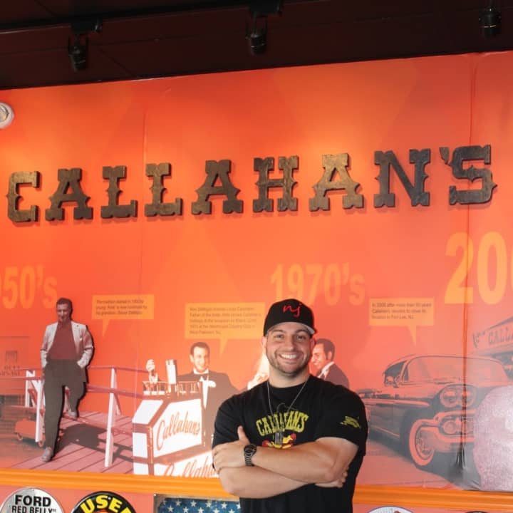 Dan DeMiglio, owner of Callahan&#x27;s, appears next to a mural in his Norwood eatery.