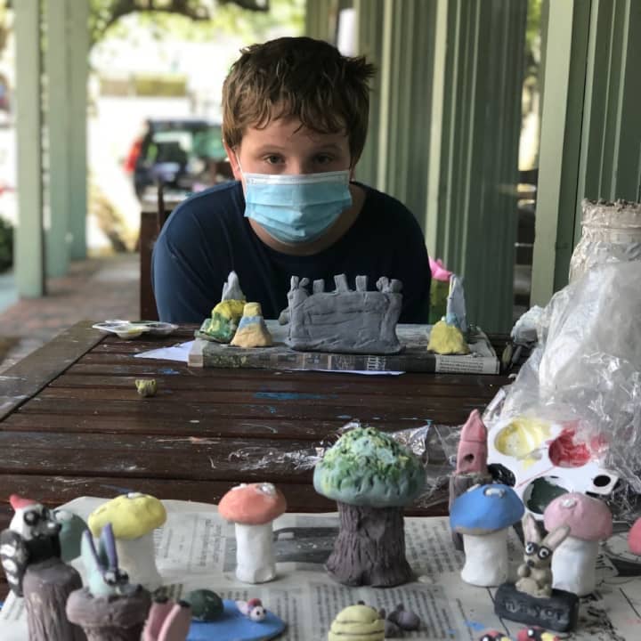 A camper works on a clay project at The Studio in Fairfield.