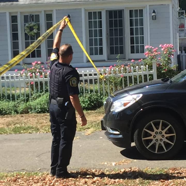An officer lets a car pull into the Lordship neighborhood in Stratford where the shooting occurred on Sept. 14.