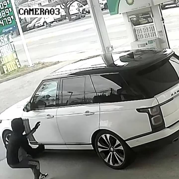 The suspect stealing the Range Rover at the gas station.