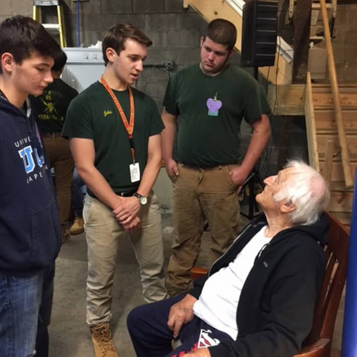 Veteran Lou Russo, 97, talks with Abbott Tech students who installed a new heating system in his house in New Fairfield.