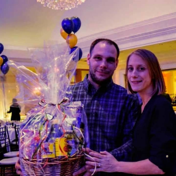 Mike and Melissa Dubis hold a basket donated by Matera&#x27;s on Park in Rutherford.