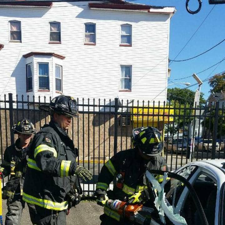 Two Paterson firemen treating a patient as EMTs.