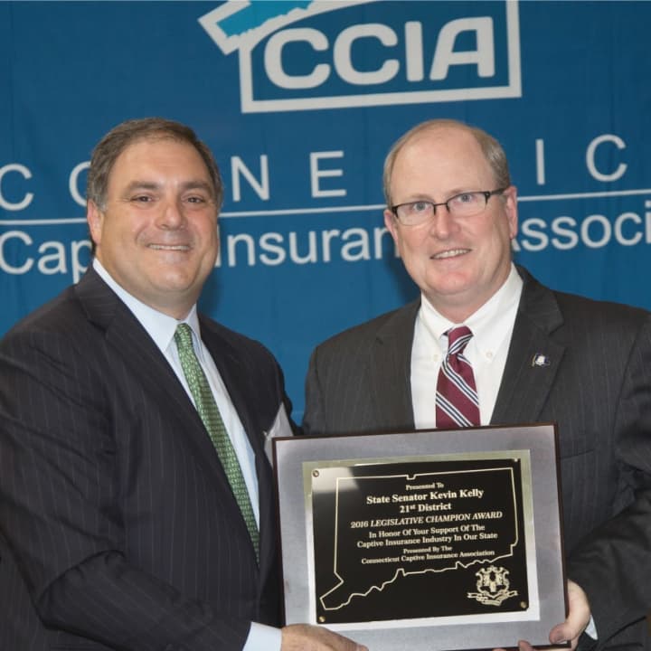 Sen. Kevin Kelly accepts the 2016 Legislative Champion Award at the Annual Captive Insurance Symposium Oct. 13 at the Sheraton Stamford.