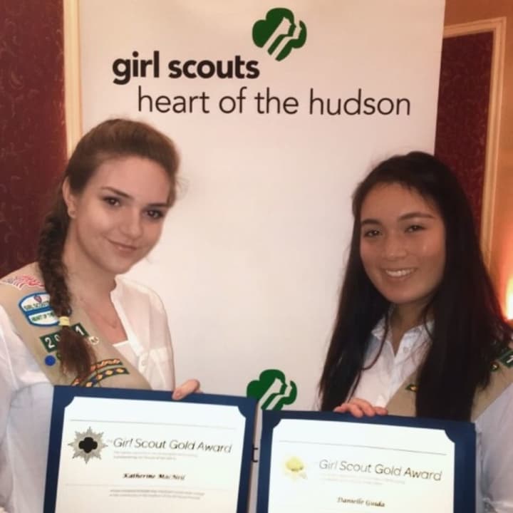 Danielle Guida and Katie MacNeil holding their award certificates at the Girl Scouts Heart of the Hudson Gold Award ceremony.