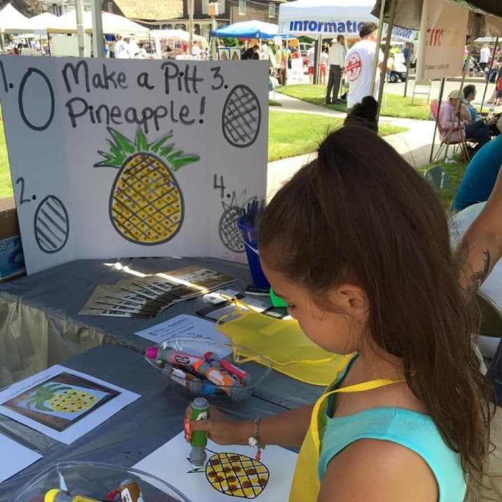 Kids colored a &quot;Pitt Pineapple&quot; -- the firm&#x27;s logo -- at the brokerage&#x27;s booth at the 2016 Stratford Main Street Festival.