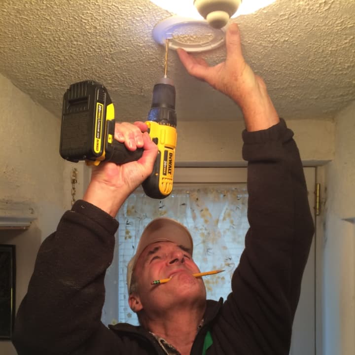 <p>Phil Marchbank drilles a hole to install a smoke detector in a a Little Ferry home for Rebuilding Bergen County on Saturday.</p>