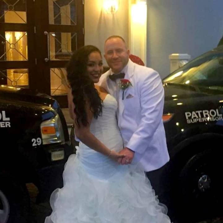 Sgt. William Houck and Officer Mariggi Lopez of the Garfield Police Department exchanged vows Sunday.