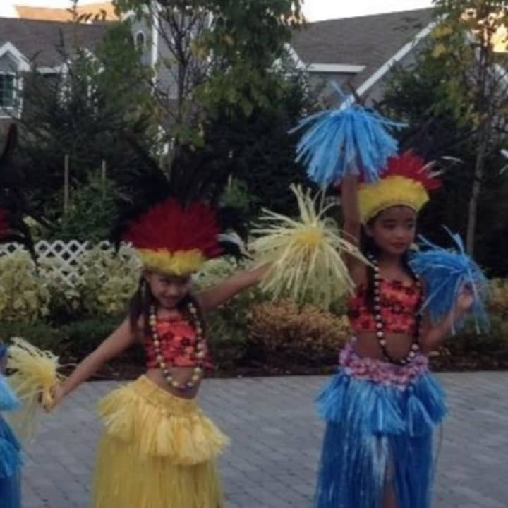 Polynesian dancers from Danbury strike a pose as they perform for seniors. 