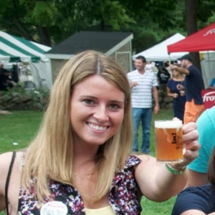 A beer lover toasts the brews from some of America&#x27;s best craft breweries at America On Tap on Saturday at Ives Concert Park in Danbury.