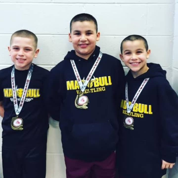 Jacob Gonzales, Jason Singer and Nicky Singer of the Mad Bull Youth Wrestling Squad in Norwalk.
