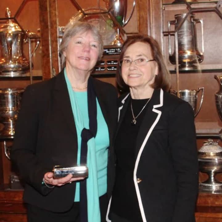 Sally Parris (left) receives Hall of Fame Induction Award from Carolyn Anderson (right).