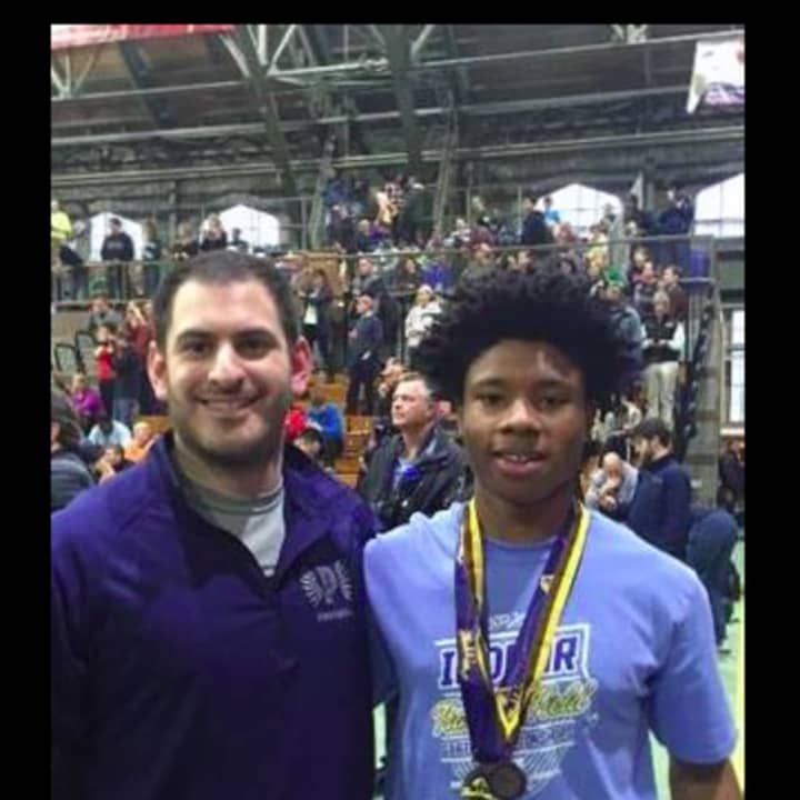 Justin Johnson, right, a student in the Pelham school district, medaled twice at the New York State Indoor Track meet. Johnson is pictured with coach Greg Kopstein.